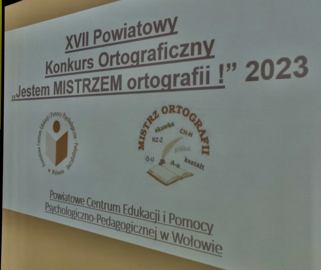 Ekran a na nim wyświetlony slajd z napisem XVII Powiatowy Konkurs Ortograficzny Jestem MISTRZEM Ortografii
